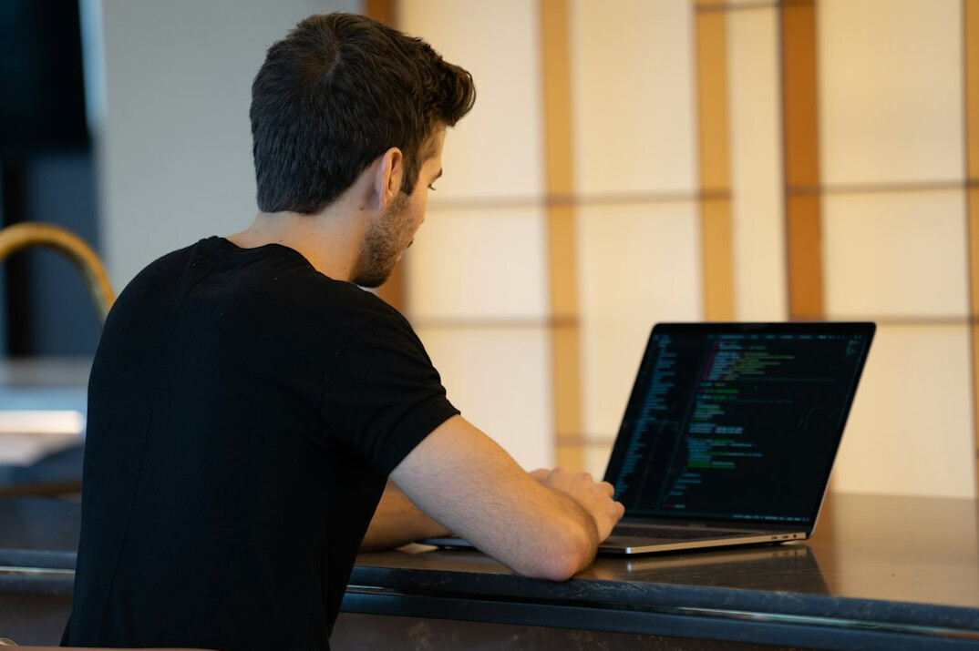 developer using laptop with code
